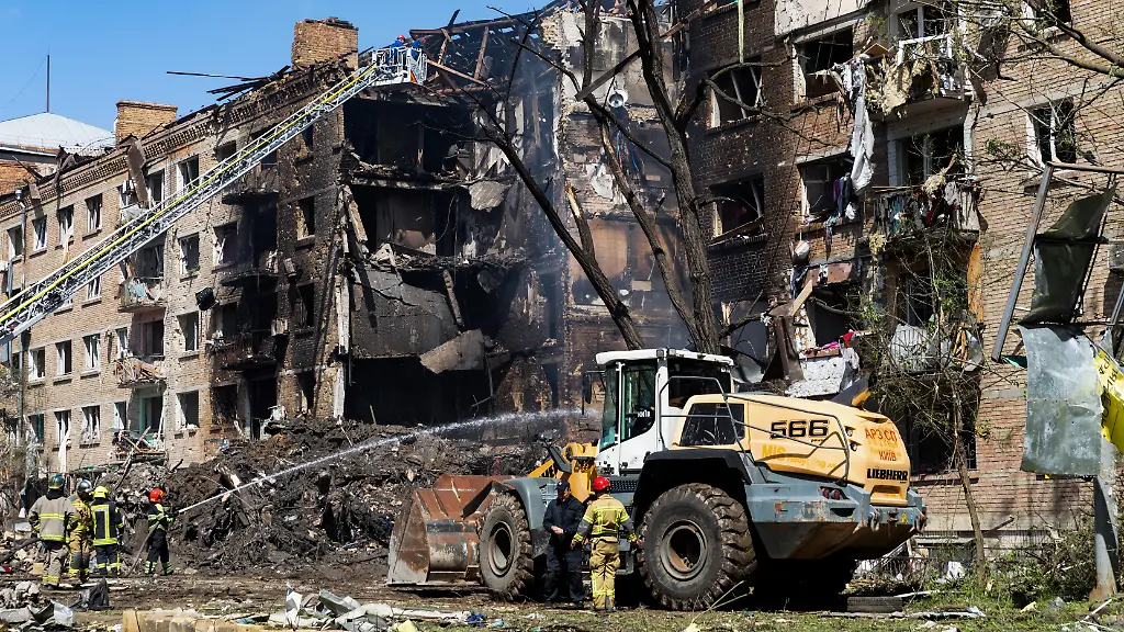 Emergency-responders-and-a-bulldozer-are-seen-clearing-debris-from-a-heavily-damaged-residential-building-in-Kyiv-following-a-massive-Russian-missile-and-drone-strike-Russia-launched-a-massive-combined-strike-on-Kyiv-and-the-Kyiv-region-utilizing-ballistic-and-cruise-missiles-as-well-as-attack-drones-Explosions-were-reported-across-all-districts-of-Kyiv-Residential-buildings-schools-and-civilian-infrastructure-sustained-damage-The-air-raid-alert-lasted-for-several-hours-The-most-severe-destruction-was-recorded-in-the-Shevchenkivskyi-Podilskyi-and-Dniprovskyi-districts-Currently-two-fatalities-have-been-confirmed-and-44-people-have-been-injured-in-Kyiv-Additional-casualties-have-also-been-reported-across-the-Kyiv-region-Medical-teams-and-emergency-responders-continue-operations-at-the-scene-According-to-preliminary-data-Russia-deployed-attack-UAVs-and-several-types-of-missiles-including-ballistic-ones-Both-Russian-and-Ukrainian-monitoring-channels-also-reported-the-use-of-the-Oreshnik-missile-in-the-city-of-Bila-Tserkva-Kyiv-region