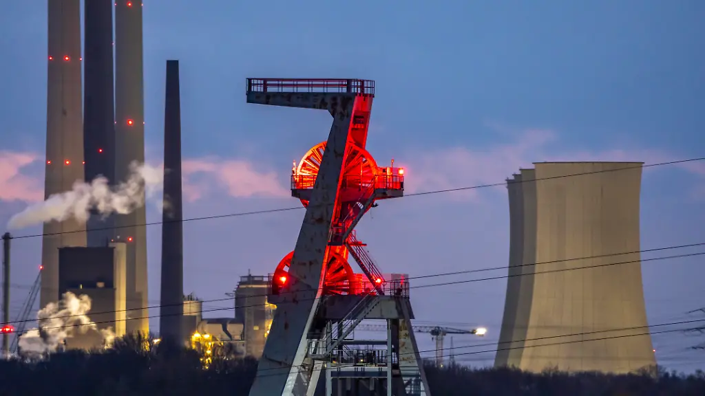 Kulisse-des-UNIPER-Kraftwerk-Scholven-im-Norden-von-Gelsenkirchen-das-ehemalige-Kohlekraftwerk-war-einst-das-leistungsstaerkste-in-Deutschland-die-Kohlebloecke-wurden-stillgelegt-2-gelten-noch-als-Systemrelevant-und-bleiben-bis-2031-als-Reserve-fuer-Spitzenlastzeiten-ein-neues-Gaskraftwerk-ist-dort-entstanden-und-mit-einer-140-MW-Anlage-im-Betrieb-und-soll-perspektivisch-auf-Wasserstoff-umgestellt-werden-produziert-neben-Strom-auch-noch-Fernwaerme-Foerdergeruest-der-ehemaligen-Steinkohlenzeche-Hugo-Schacht-2-NRW-Deutschland