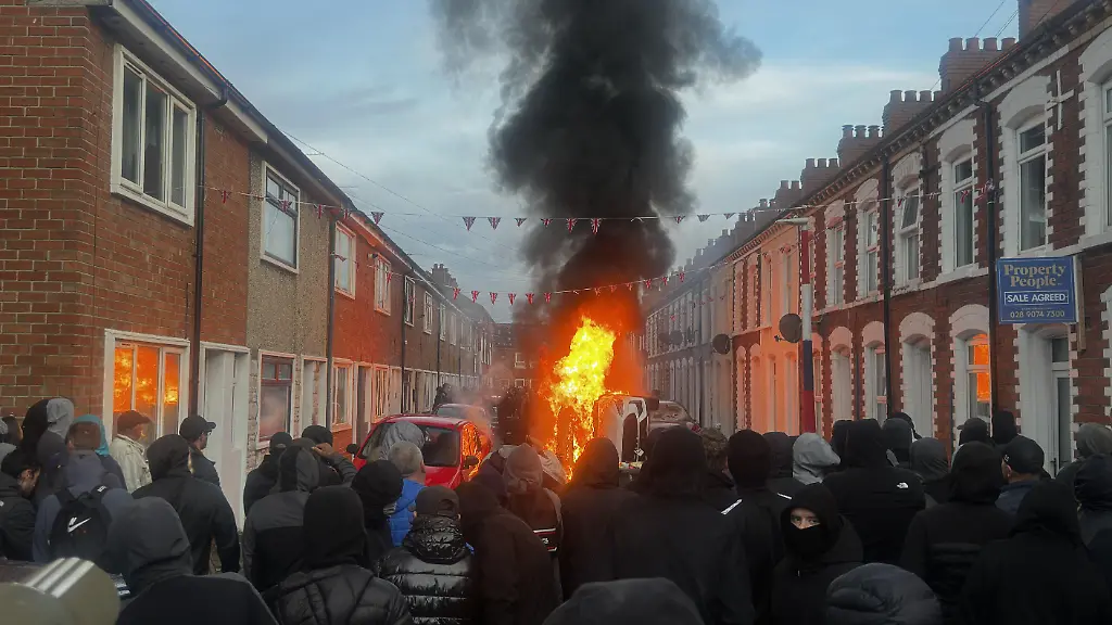 North-Belfast-stabbing-Vehicles-set-on-fire-by-protesters-on-Lendrick-Street-in-Belfast-as-disorder-flared-in-response-to-Monday-night-s-stabbing-attack-in-the-city-A-30-year-old-man-arrested-in-connection-with-the-Belfast-stabbing-attack-has-been-charged-with-attempted-murder-and-will-appear-in-court-in-the-city-on-Wednesday-the-Police-Service-of-Northern-Ireland-has-said-Picture-date-Tuesday-June-9-2026