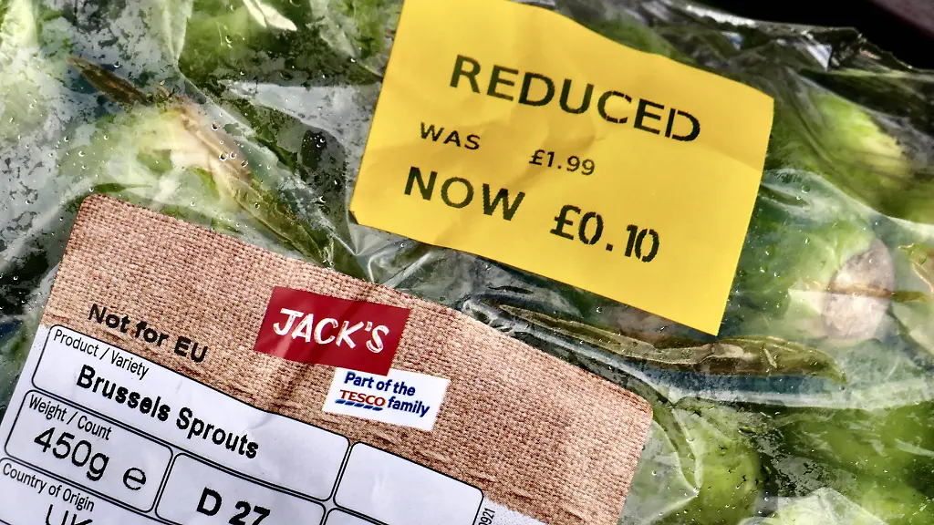 The-Christmas-Supermarket-vegetable-price-war-risked-devaluing-food-Baskets-full-of-vegetables-associated-with-a-traditional-Christmas-dinner-are-reduced-massively-in-a-supermarket-Prior-to-the-big-day-festive-shoppers-were-snapping-up-carrots-parsnips-and-Brussels-sprouts-for-as-little-as-5p-a-packet-NFU-Scotland-says-the-bargains-come-at-a-cost-to-farmers-and-the-value-of-food-saying-that-the-aggressive-discounting-risks-devaluing-domestic-produce