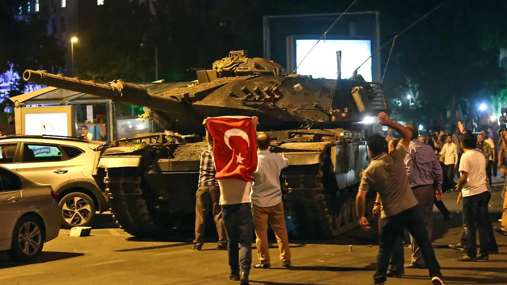 A-tank-moves-into-position-as-Turkish-people-attempt-to-stop-them-in-Ankara-Turkey-early-Saturday-July-16-2016-Turkey-s-armed-forces-said-it-fully-seized-control-of-the-country-Friday-and-its-president-responded-by-calling-on-Turks-to-take-to-the-streets-in-a-show-of-support-for-the-government-A-loud-explosion-was-heard-in-the-capital-Ankara-fighter-jets-buzzed-overhead-gunfire-erupted-outside-military-headquarters-and-vehicles-blocked-two-major-bridges-in-Istanbul