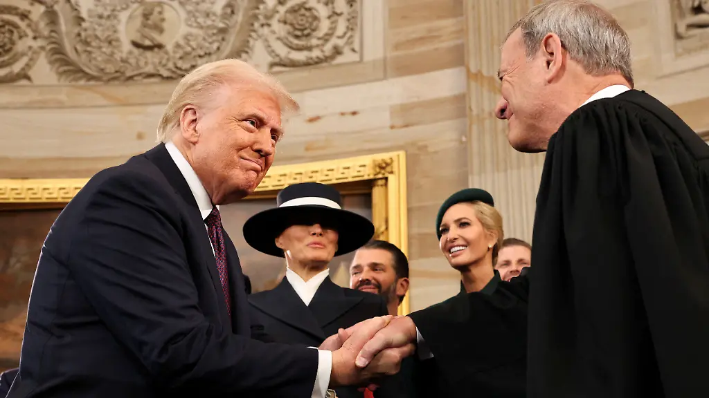 FILE-PHOTO-U-S-President-Donald-Trump-shakes-hands-with-U-S-Supreme-Court-Chief-Justice-John-Roberts-R-as-Melania-Trump-Donald-Trump-Jr-and-Ivanka-Trump-look-on-after-being-sworn-in-during-inauguration-ceremonies-in-the-Rotunda-of-the-U-S-Capitol-on-January-20-2025-in-Washington-DC