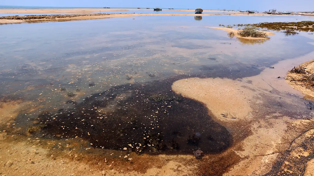 Dark-oil-residue-collects-in-shallow-coastal-waters-on-Qeshm-Island-Iran-Thursday-Aug-13-2026-amid-ongoing-wartime-attacks-on-vessels-and-infrastructure-in-and-around-the-Strait-of-Hormuz-though-the-spill-s-source-has-not-been-independently-determined